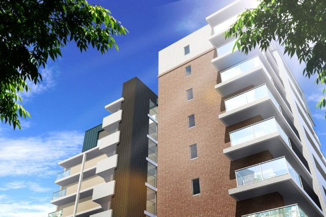 緑に囲まれた茶色の壁のマンション